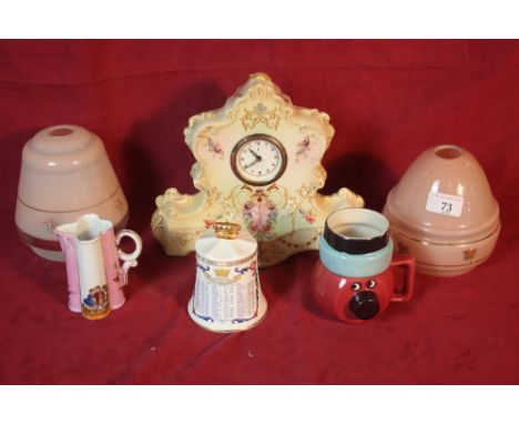 An early 20th Century transfer printed porcelain mantel clock; two opaque glass light shades; a Royal commemorative bell etc.