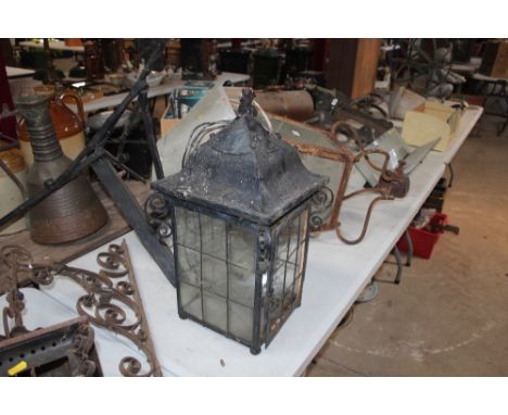 A wrought metal porch lamp and bracket 