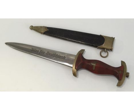 A SECOND WORLD WAR NAZI SA DAGGER, with wooden grip and engraved blade.