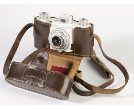 AN ILFORD ADVOCATE CAMERA, ivory enamel body, with a Dallmeyer F3.5/35 lens, serial no. 462591. In a leather case with strap.