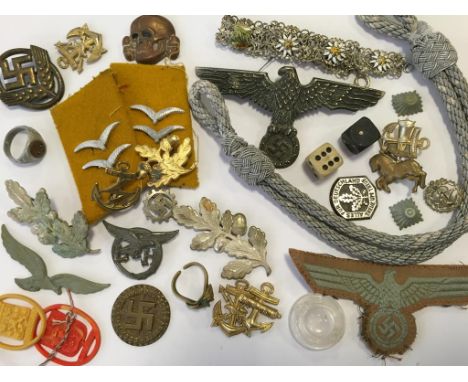 A NAZI CAP BADGE, cloth badges and other items. Notice: No historical Nazi items are guaranteed to be genuine, we ask buyers 