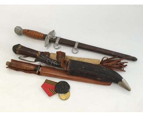 A SECOND WORLD WAR NAZI DAGGER, and other knives with scabbards.