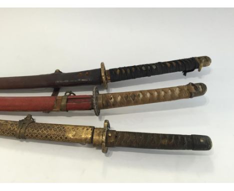 A JAPANESE SECOND WORLD WAR ISSUE KUTANA, with cord and shagreen grip in a leather scabbard, and two other similar kutanas. (