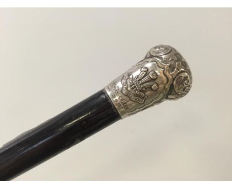 A WELSH REGIMENT WALKING STICK with a silver handle engraved 'Presented to Colonel Sergeant Owen Evans on his retirement from