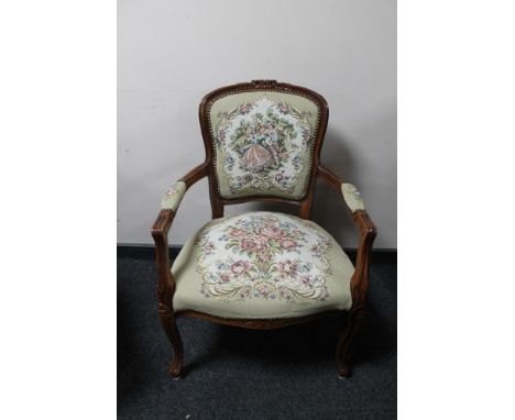 An antique style carved walnut armchair in tapestry fabric 