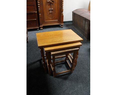 A nest of three light oak tables 