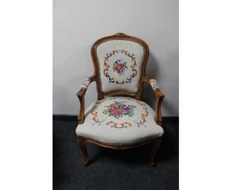 An antique style carved walnut armchair in tapestry fabric 