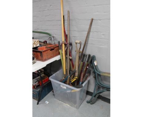 A pair of metal garden bench ends together with a box of tools