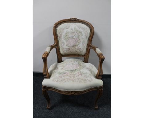 An antique style carved walnut armchair in tapestry fabric 