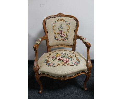 An antique style carved walnut armchair in tapestry fabric 