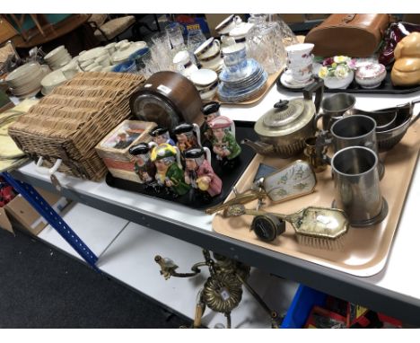 Two trays of early twentieth century oak mantel clock, Toby jugs, silver plate and pewter wares, vintage picnic set in basket