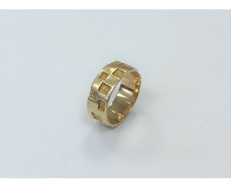 A 9ct gold textured band ring, size P1/2.  CONDITION REPORT: 5.5g