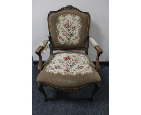 A carved walnut armchair with tapestry covering 