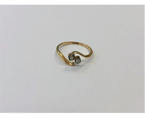 A two stone diamond crossover ring, size N1/2.  CONDITION REPORT: Indistinctly stamped. 1.7g. 