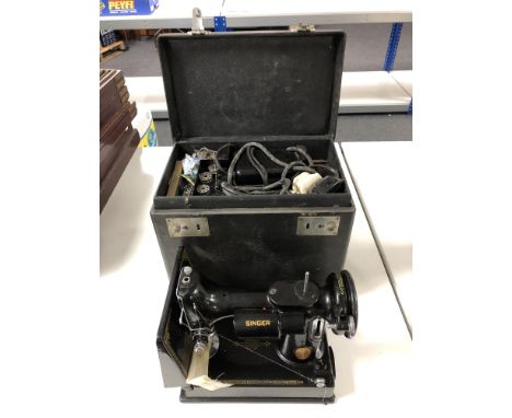 A vintage electric singer sewing machine in box together with accessories, pedal.