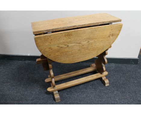 A light oak drop leaf table 