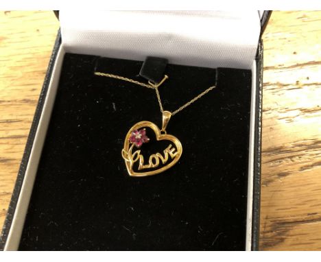 A yellow gold ruby and diamond set heart pendant