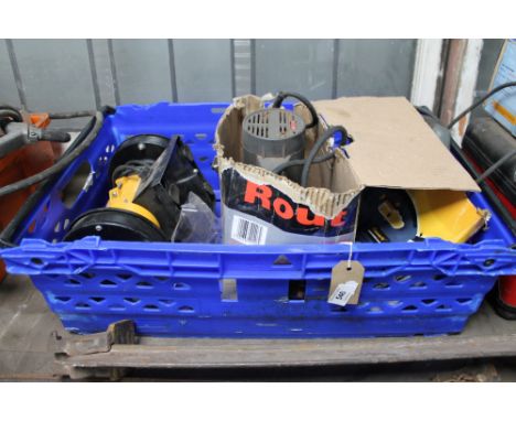 A crate of bench grinder, router, jigsaw