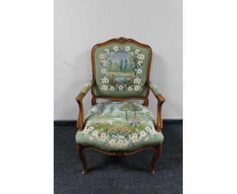 An antique style carved walnut armchair in tapestry fabric 