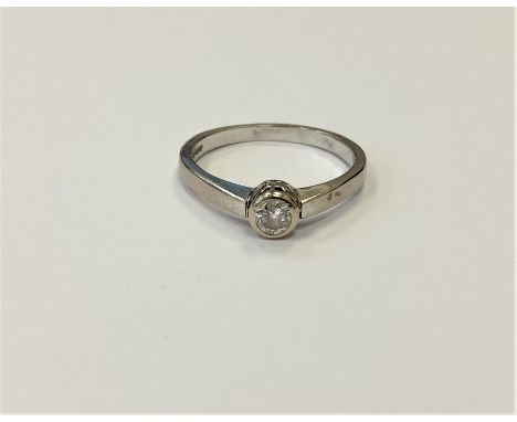 An 18ct white gold solitaire diamond ring, the brilliant cut stone weighing an estimated at 0.25 carat, size S.  CONDITION RE