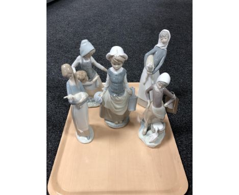 A Lladro figure of a girl carrying milk churns together with four other Spanish figures.
