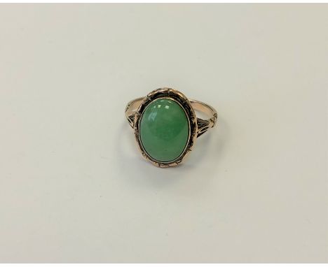 A gold and jade ring, size N1/2.  CONDITION REPORT: 9ct gold. 4.2g. The jade measures 14mm by 10mm by 5mm. 