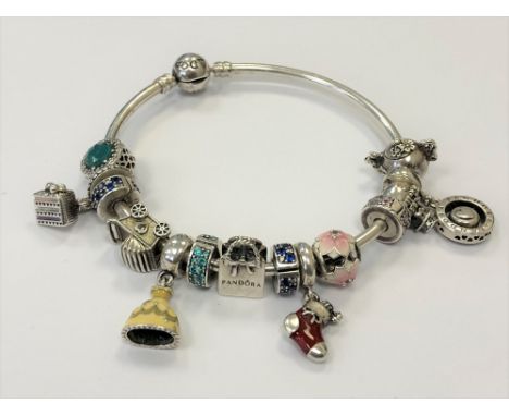 A Pandora silver bangle strung with charms. 