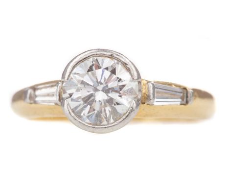 DIAMOND SOLITAIRE RING,set with a round brilliant cut diamond of approximately 1.35 carats, flanked by two tapered baguette c