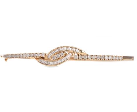 DIAMOND BANGLE,set with round brilliant and baguette cut diamonds totalling approximately 1.25 carats, in nine carat gold, 10