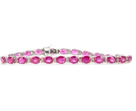 RUBY AND DIAMOND BRACELET,set with oval rubies totalling approximately 9.16 carats interspaced by pairs of diamonds totalling