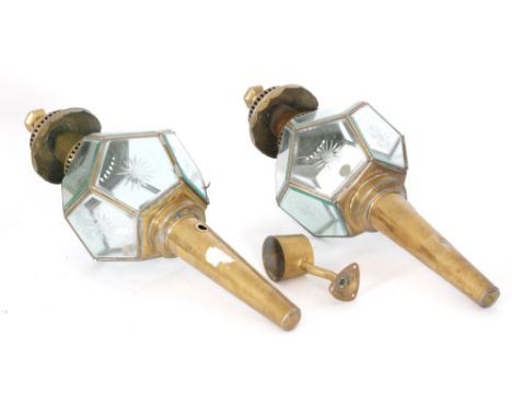 A pair of early 20th Century brass carriage lamps, each bevelled glass panel engraved with a floral design, height 66cm (2)