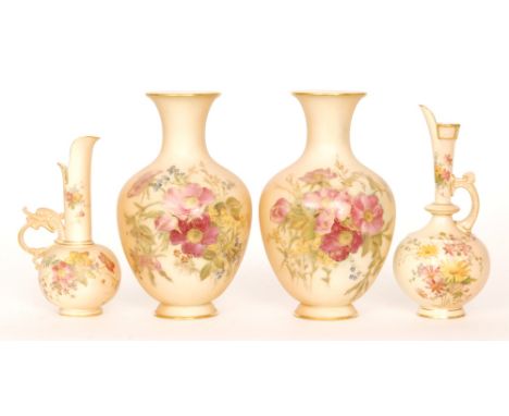 A pair of early 20th Century Royal Worcester blush ivory footed baluster vases decorated with sprays of flowers, puce mark wi