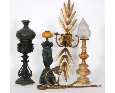 A late 19th Century metal oil lamp in the Aesthetic taste, together with another oil lamp; the base formed as the Three Grace