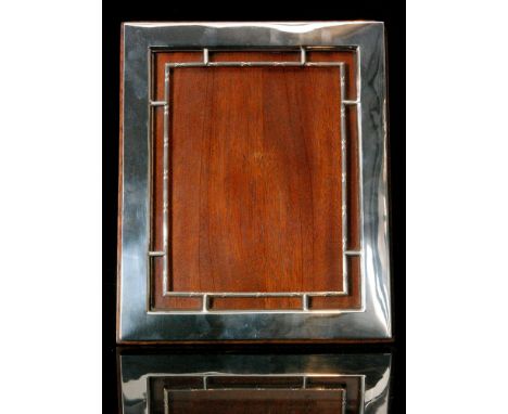 An Edwardian hallmarked silver rectangular easel back photograph frame, the plain border with ribbon tied fret work detail, h