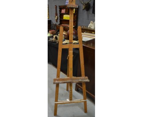 A pine artist's easel of trestle form, together with a later beech example. (2)From the estate of the late Richard Beer