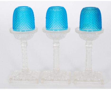 A late 19th Century pressed glass Fairy Night Light with a blue strawberry diamond moulded dome raised to a pressed flint gla