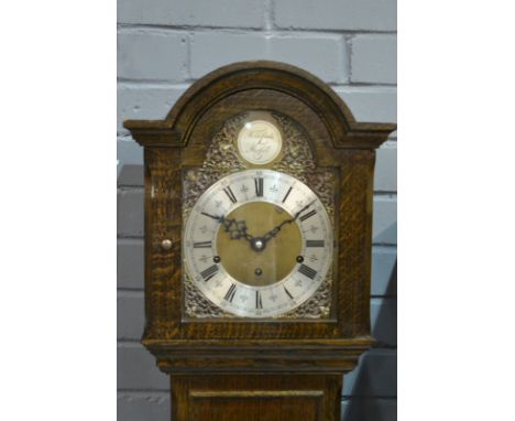 A 20th Century oak Grandmother clock, the silvered arch dial inscribed Tempus Fugit over a panelled base, height 162cm