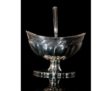 A George III hallmarked silver swing handled pedestal sugar basket of oval outline with bright cut frieze panel and fluted gi