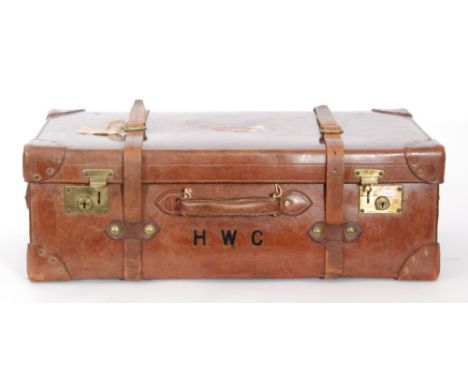 A 20th Century stitched brown leather trunk with tray interior initialed H.W.C, the brass locks stamped Greaves Ltd Birmingha