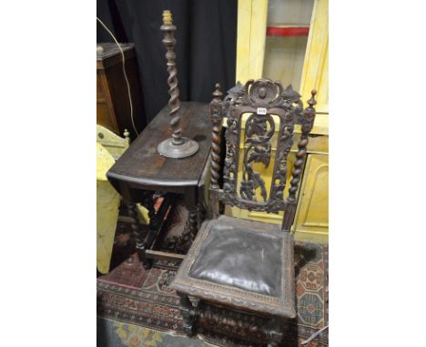 An early 20th Century oak barleytwist gate-leg table of oval form, together with a barleytwist table lamp and a Victorian oak