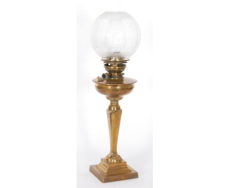 An Edwardian brass oil lamp the slender stepped column on a square base below an acid etched shade, height 64cm