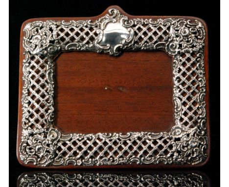 An Edwardian hallmarked silver mounted easel back photograph frame of rectangular outline, the wooden mount with applied fret