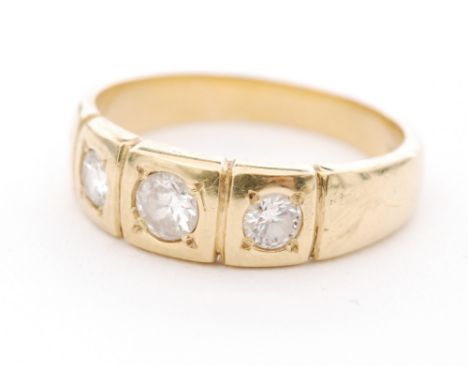 A hallmarked 18ct three stone diamond ring, three graduated round brilliant cut diamonds gypsy set to a three panel head with