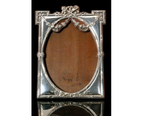 An Edwardian hallmarked silver mounted easel back photograph frame of rectangular outline, the wooden mount with floral garla