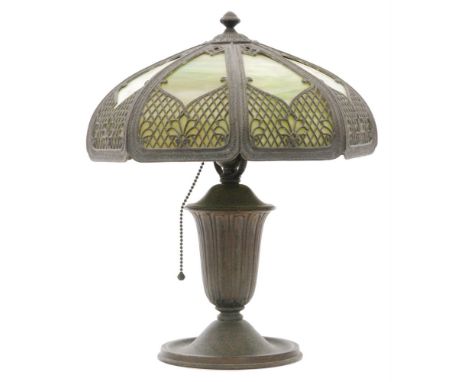 An early 20th Century base metal table lamp with green malachite panel glass shade, height 38cm. S/D. 