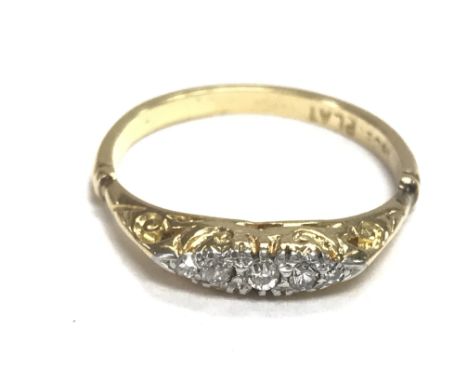 An 18ct gold ring set with small diamonds. Size P and 2.78g Postage B