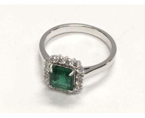 18ct white gold emerald cut emerald and RBC diamond square cluster ring, boxed. Emerald 1.45ct. Diamonds 0.42ct. Ring size N.