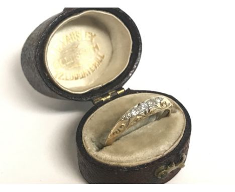 An 18ct gold ring set with a row of small chip diamonds , 2.6g size N. Postage category A