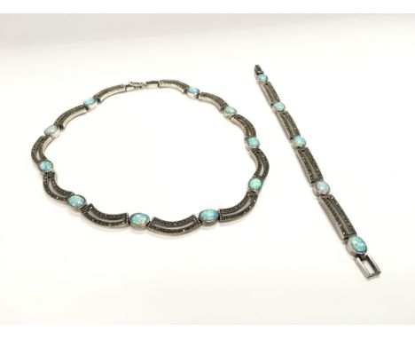 A silver bracelet and necklace set with marcasite and opal doublet.