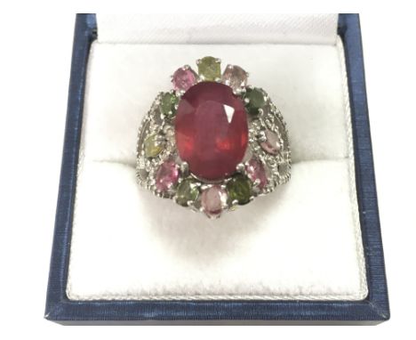 Unusual cluster dress ring in silver set with an oval treated ruby surrounded by multi coloured tourmalines and diamonds, box